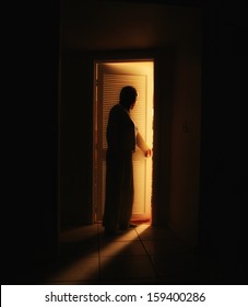  A Person Outside A Bedroom Door 