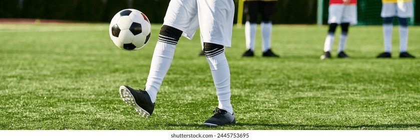 A person passionately kicks a soccer ball on a vibrant field, showcasing skill and determination in a dynamic sports moment. - Powered by Shutterstock