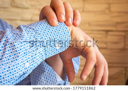 
Person - patient shows localization of pain, numbness, paralysis or inability to move hand in wrist. Concept photo of arm fracture, tunnel syndrome, nerve damage and other symptoms from upper limb