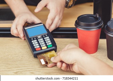 PErson Paying Bill With Credit Card For Coffee To Go