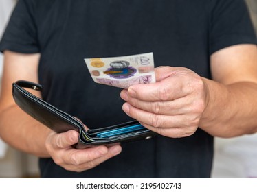 A Person Paying Cash For A Purchase.