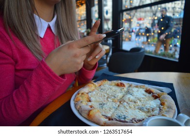 A Person Photographing Their Meal, Pizza, In A Restaurant. Photographing Food. Insta Food.