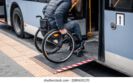 Person with a physical disability enters public transport with an accessible ramp. - Shutterstock ID 2089655170