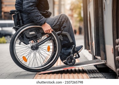 Person with a physical disability enters public transport with an accessible ramp.