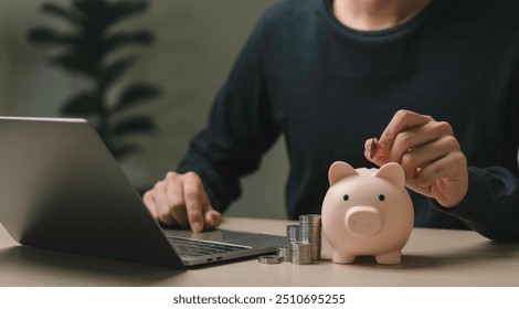 person placing a coin into a piggy bank, symbolizing saving money, financial planning, online banking and economic. stack coins the piggy bank of accumulating wealth, managing expenses and investment. - Powered by Shutterstock