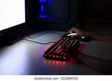 Person Playing Games On A Gaming Keyboard And Mouse On A White Desk, Gaming Set Up, Gaming Concept