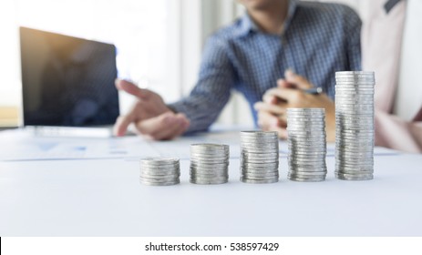 person pointing writing goals on a paper,writing business plan at workplace,man holding pens ,papers,notes in documents,Saving money concept,graph, stacks of coins ,chart and pen. - Shutterstock ID 538597429