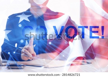 A person points with one finger while wearing a dark suit. The background shows the United States flag. The text says Go Vote! This scene encourages participation in elections.