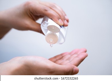 Person Pouring Antiseptic Solution Into His Hand For Hand Cleaning