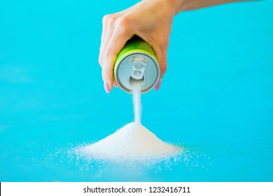 Person Pouring Sugar Out Of Soft Drink Can