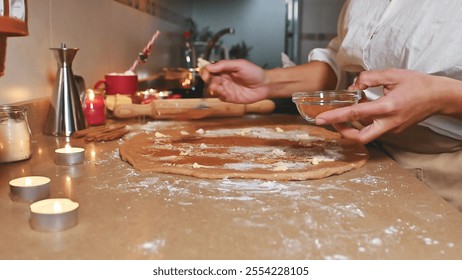 Person preparing festive holiday cookies with warm candle ambiance - Powered by Shutterstock