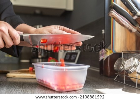 A person preparing vegetables in the kitchen