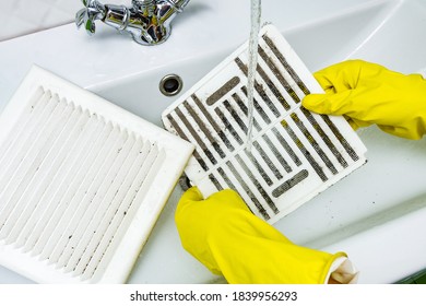 Person In A Protective Rubber Glove Washes In The Sink Air Filter Of The Ventilation Return Duct Blocked By Dust And Debris. Cleaning Service.