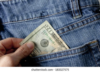 A Person Pulling A Twenty Dollar Bill Out Of A Denim Blue Jean Back Pocket