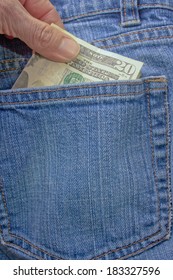 A Person Pulling A Twenty Dollar Bill Out Of A Denim Blue Jean Back Pocket