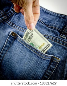 A Person Pulling A Twenty Dollar Bill Out Of A Denim Blue Jean Back Pocket