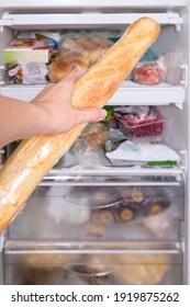 A Person Putting A Loaf Of Wheat Bread, Baguette In Reserve On A Shelf Of A Home Freezer, Long Life Food Storage Concept.