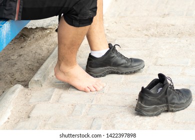 Person Putting On Pair Of Shoes.