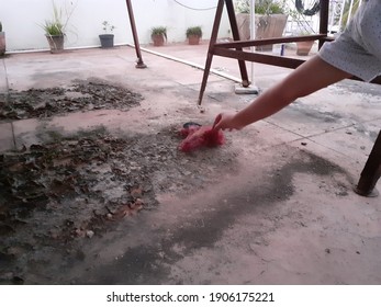 A Person Reaching Down To Clear Debris And Dirt On The Pavement In The Garden - Image Of Doing Odd Jobs, Maintenance Concept, Cleaning Time.