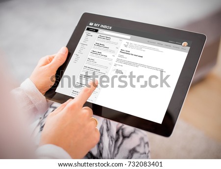 Person reading e-mail on tablet. All content is made up.