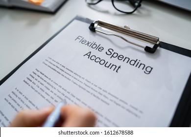 Person Reading Flexing Spending Account Fineprint At Desk
