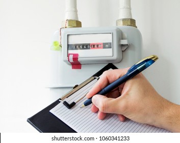 Person Reading The Gas Meter In The Private House, Counter For Distribution Domestic Gas. Cropped Image, Selective Focus.