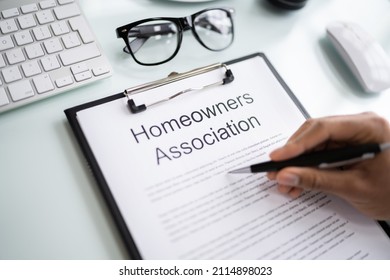 Person Reading HOA Rules And Regulations Document