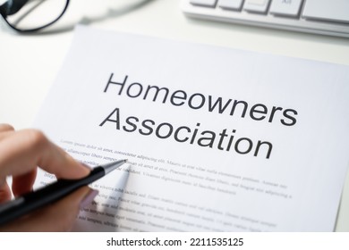 Person Reading HOA Rules And Regulations Document