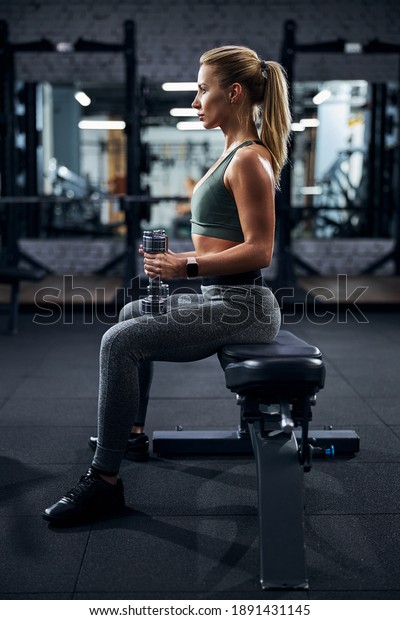 Person remaining in the\
same position with a straight back while holding the top part of\
the dumbbells