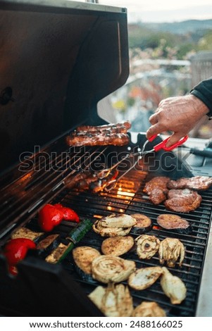 Similar – Man cooking on a barbecue