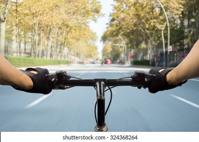person riding a bicycle along a road in Barcelona Spain - Powered by Shutterstock