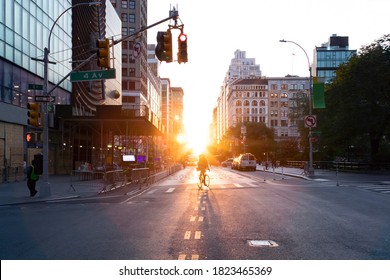 Person Riding A Bicycle Into The Sunset On 14th Street At Union Square In Manhattan, New York City NYC