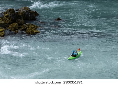 a person is riding a kayak down the beautiful Goðafoss(godafoss waterfall), Fossholl, Iceland. 
