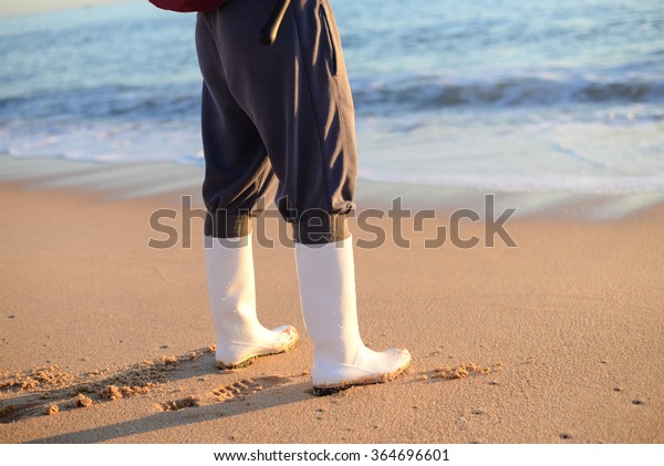 Rubber Boots Over Sea Beach Stock Photo 