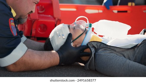 Person, safety and emergency on road with oxygen for life support, medical response to trauma with ventilation. Accident, first aid or health insurance or air mask for breath on street, ems or crisis - Powered by Shutterstock