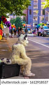 Person Sat In Furry White Tiger Costume Waiting For Pride Parade To Start