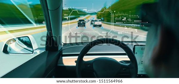 Person in\
a self driving autonomous car with\
autopilot