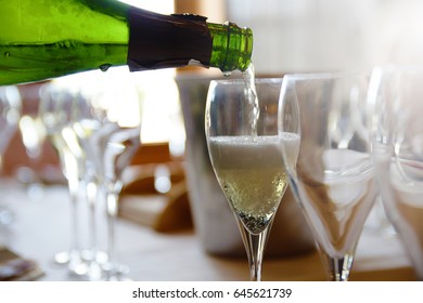 A Person Serving Some Champagne In A Glass In A Tasting. Some Carbonic Bubbles.