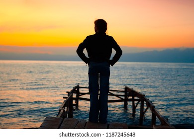 Person Silhouette Standing On Dock Looking Stock Photo 1187245648 ...