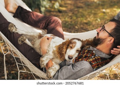Person Sleeping With His Dog In A Hammock In Beautiful Summer Scene