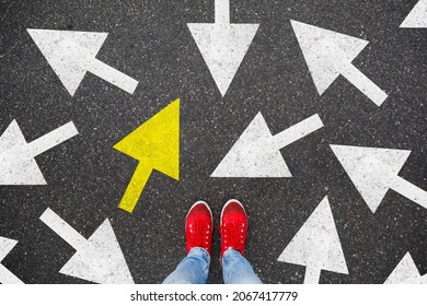 Person standing on the road to future life with many direction sign point in different ways and only yellow one. Decision making is very hard, but you have a choice and right way - Powered by Shutterstock