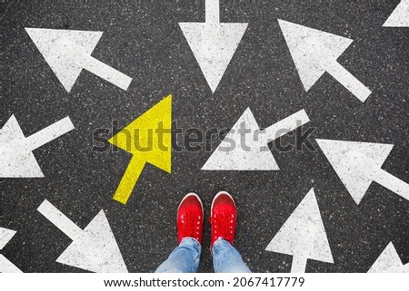 Person standing on the road to future life with many direction sign point in different ways and only yellow one. Decision making is very hard, but you have a choice and right way