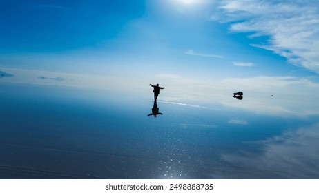 Person standing in the Salar de Uyuni - Bolivia, beautiful travel photo - Powered by Shutterstock