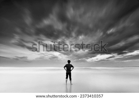 Similar – Hallig Gröde | Senior citizen stands in the calm North Sea at low tide and raises her hands to the sky