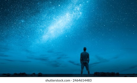 Person Stargazing Under a Starry Night Sky with the Milky Way - Powered by Shutterstock