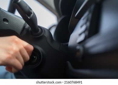 The Person Starts The Car With A Key. Close-up - Hand Under The Wheel Of The Transport