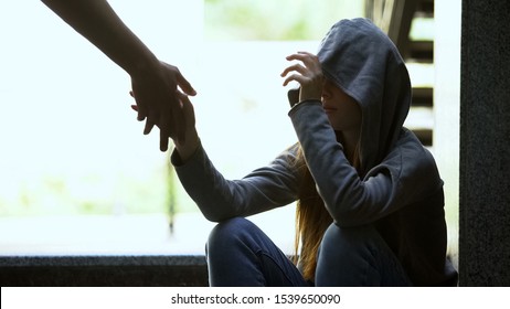 Person Stretching Helping Hand To Lonely Depressed Teen Girl, Support And Aid