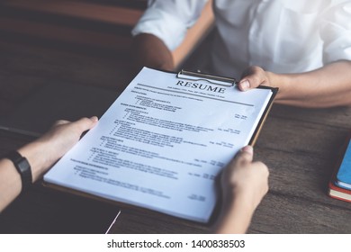 Person submits job application, Interviewer reading a resume. - Shutterstock ID 1400838503