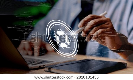 A person in a suit interacts with a laptop while a large lifebuoy icon appears superimposed on the screen symbolizing safety or support