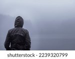 Person surrounded by fog in front of a lake in the azores
